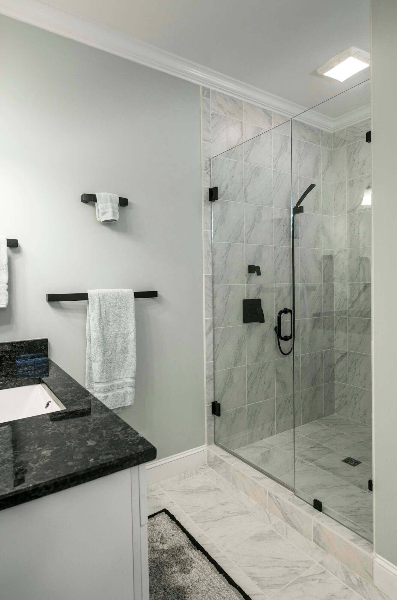 modern bathroom with glass shower and marble tile 1 1